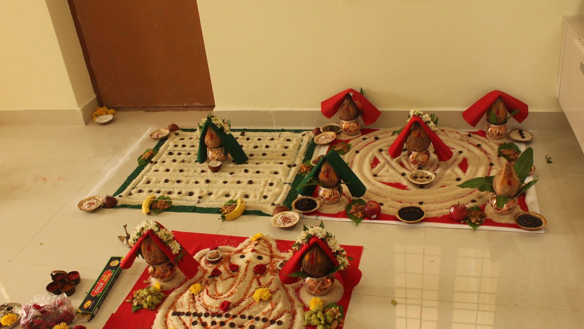Kalashes on rice mandalas laid out for a griha pravesh puja in a new home